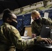 U.S. Army Lt. Col. Dee Watkins views a computer with Senior Airman Joielle Cobb-Sanders, as part of keeping track of units that have out processed from the Capitol Response mission