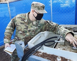 Sgt. 1st Class Jack Riley, LSB, Detachment 11, checks the fuel gauge for the power generation