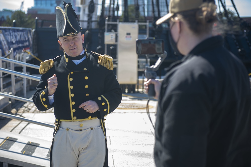 Commander John Benda, commanding officer of USS Constitution, conducts a live tour about the Navy’s first enlisted female Loretta Walsh