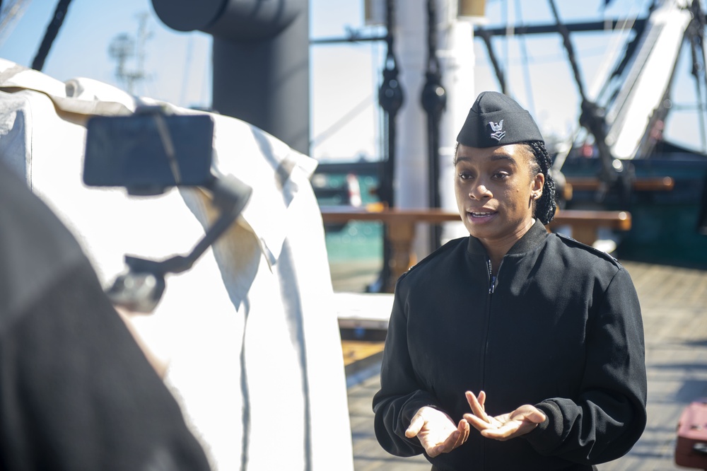 Aviation Ordnanceman 2nd Class Jennifer Jordan, assigned to USS Constitution, conducts a live tour about the Navy’s first enlisted female Loretta Walsh