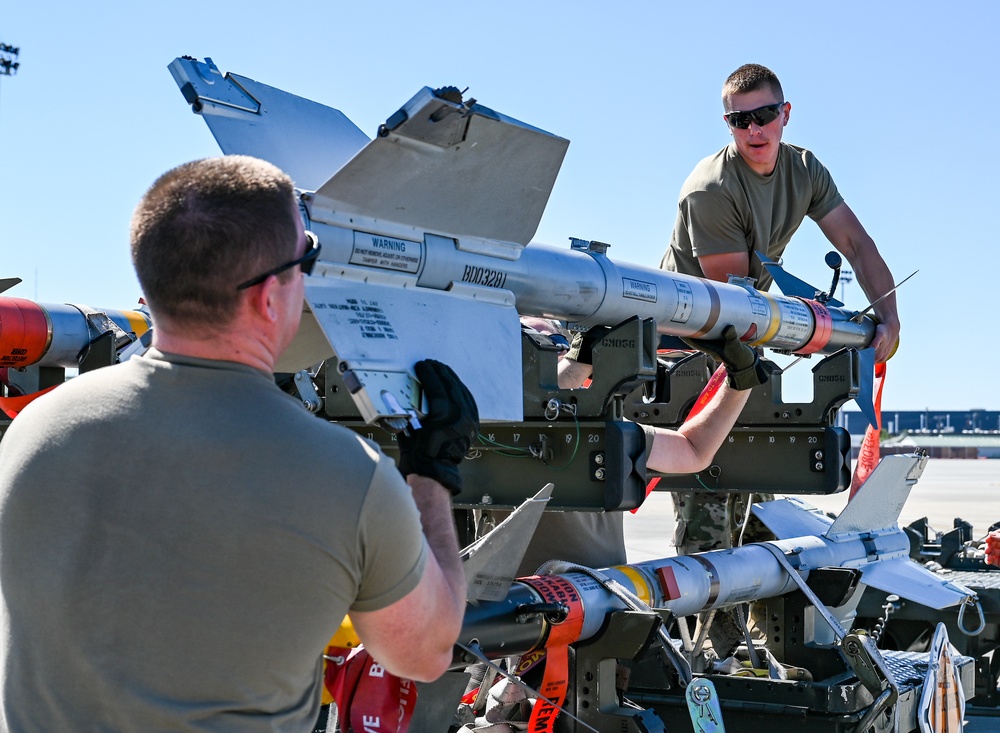 South Dakota Air Guardsmen load munitions on F-16s