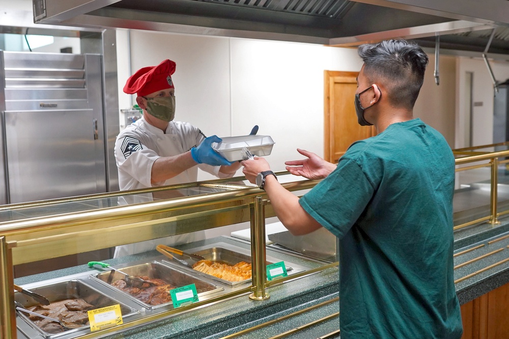 Team Hill leadership serve dinner the members of Hill's Hearts Apart Program.