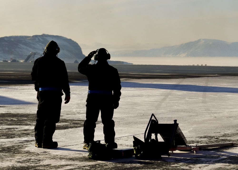 U.S. Air Force Airmen from the 148th Maintenance Squadron await the arrival of F-16s at Thule Air Base