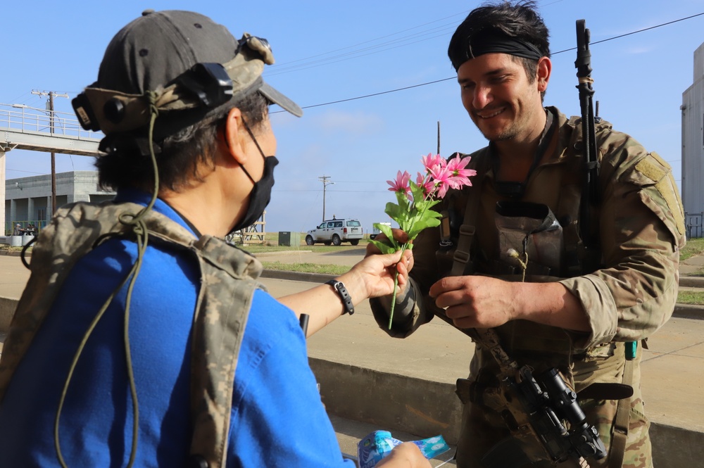 1st Brigade Combat Team 82nd Airborne Division  Soldier buys flowers from role player during JRTC rotational training 21-05