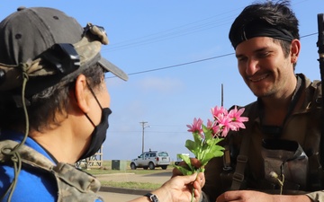 1st Brigade Combat Team 82nd Airborne Division  Soldier buys flowers from role player during JRTC rotational training 21-05