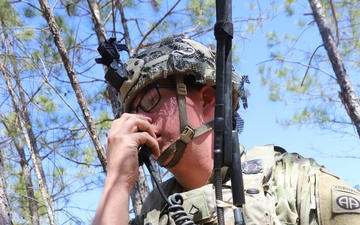 1st Brigade Combat Team 82nd Airborne Division Soldier make call on field radio in pine forest during training