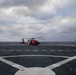 U.S. Coast Guard helicopter refuels aboard USS Arlington after a medical evacuation