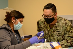 Lovell FHCC Covid-19 Vaccination staff works together to “get shots in the arms of the willing”