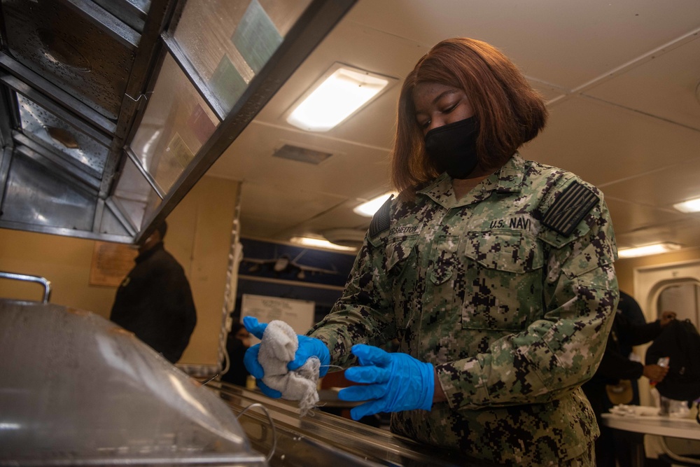 Sailor cleaning Mess deck