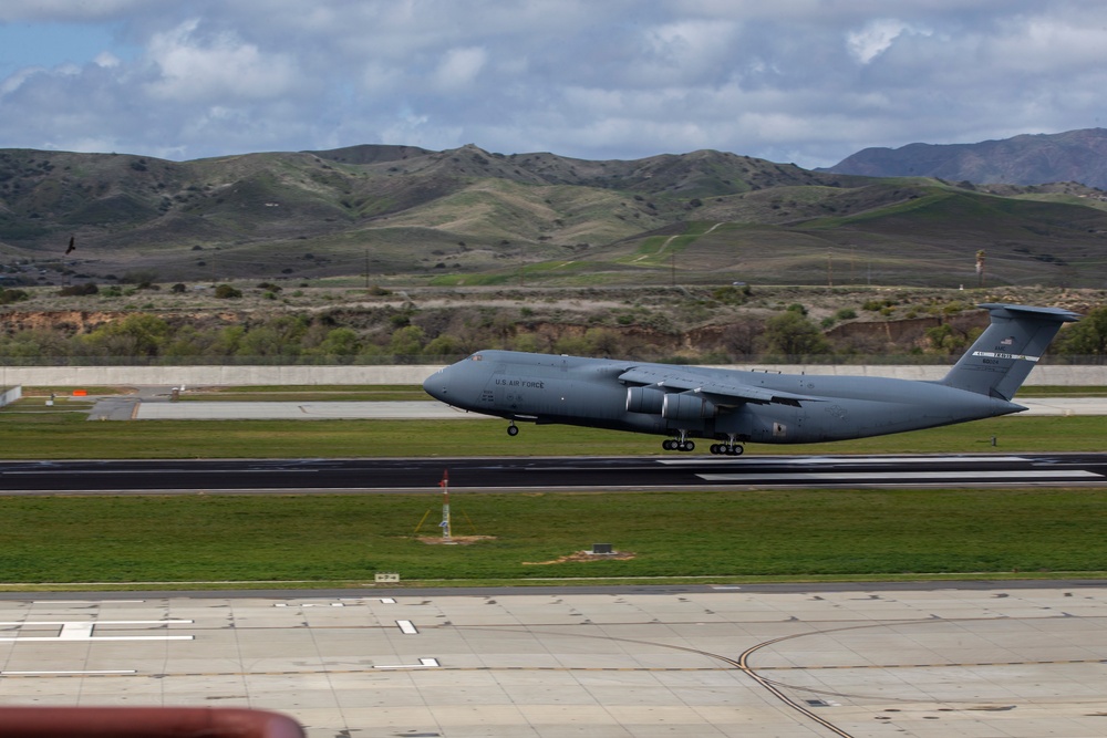 Marines, airmen load helicopters into Super Galaxy for deployment
