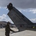 Marines, airmen load helicopters into Super Galaxy for deployment