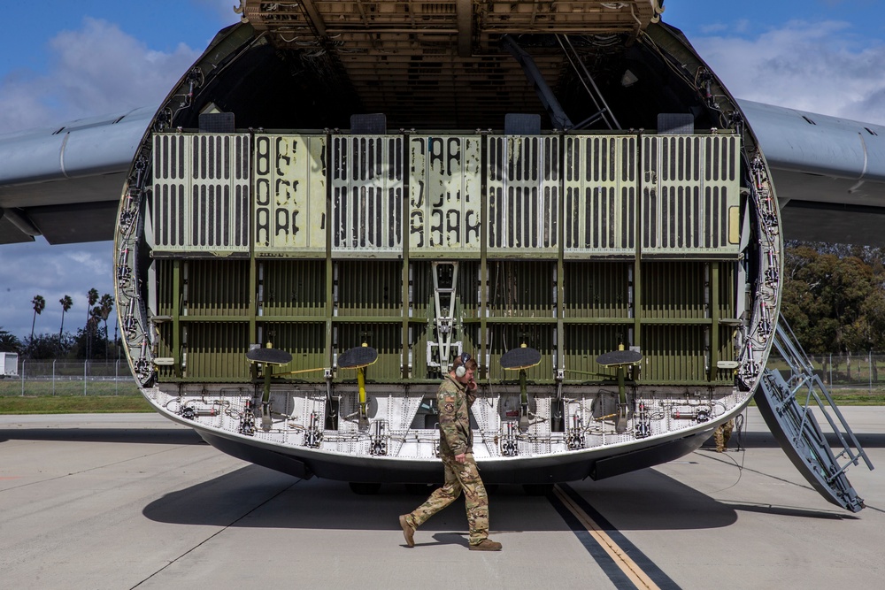 Marines, airmen load helicopters into Super Galaxy for deployment