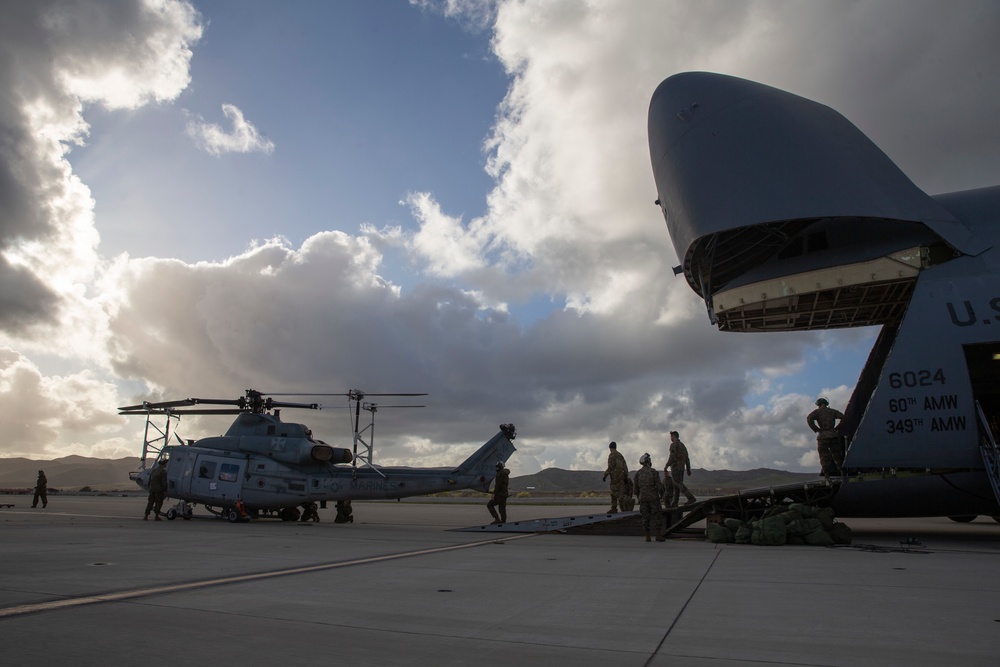 Marines, airmen load helicopters into Super Galaxy for deployment
