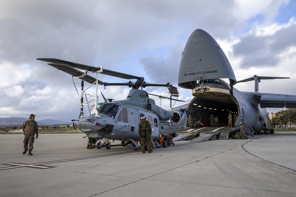 Marines, airmen load helicopters into Super Galaxy for deployment