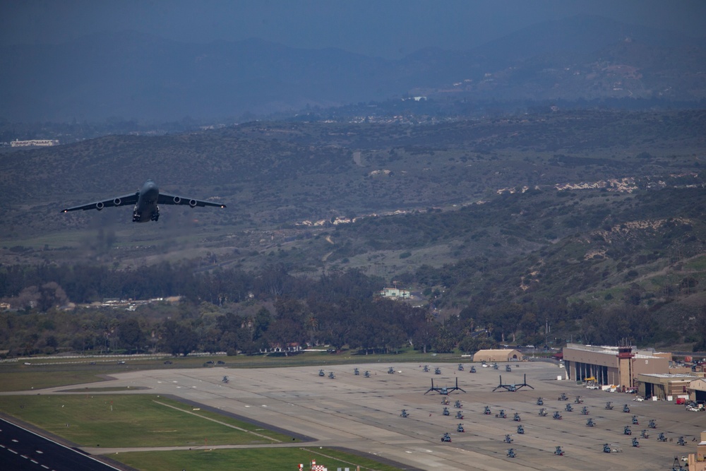 Marines, airmen load helicopters into Super Galaxy for deployment
