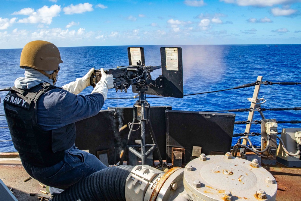 Master-at-Arms 1st Class Byron Hunt, mans the .50 caliber machine gun during a live-fire-exercise