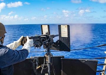 Master-at-Arms 1st Class Byron Hunt, mans the .50 caliber machine gun during a live-fire-exercise