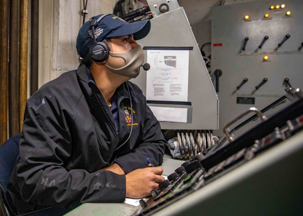 Gunners Mate 2nd Class Jacob Lazos conducts testing on Barry's Mark 45 5-inch gun