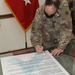 Army Reserve general signs April as SAAPM proclamation at Camp Arifjan, Kuwait