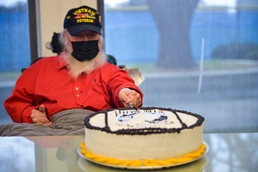 Retired Major Irving Torres-Rivera cuts the cake at commemoration ceremony