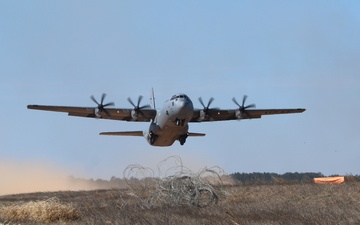 U.S Airforce cargo plane take off in dust filed with blue sky at the Joint Readiness Training Center