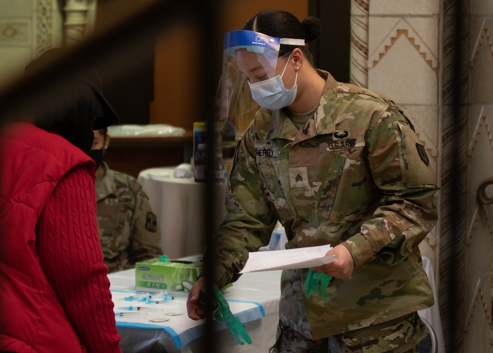 U.S. Army Soldiers welcome community members for their second inoculation of the COVID-19 vaccine in Trenton, NJ