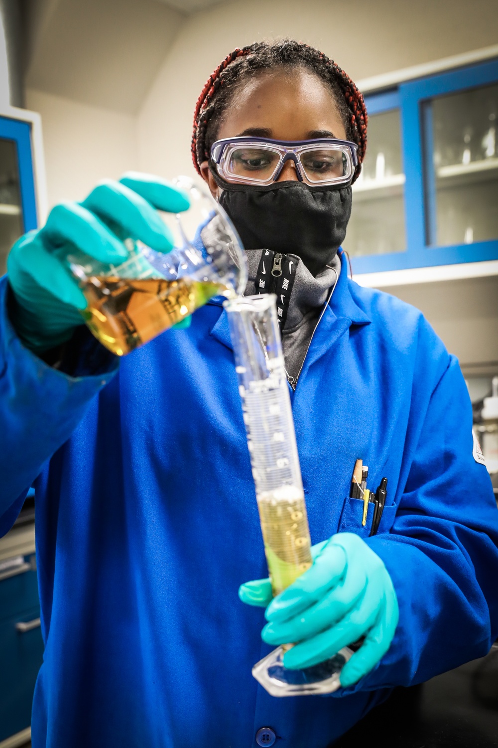Scientist Keshia Capers accurately measures an aliquot of solution to be used in sample analyses