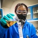 Scientist Keshia Capers accurately measures an aliquot of solution to be used in sample analyses