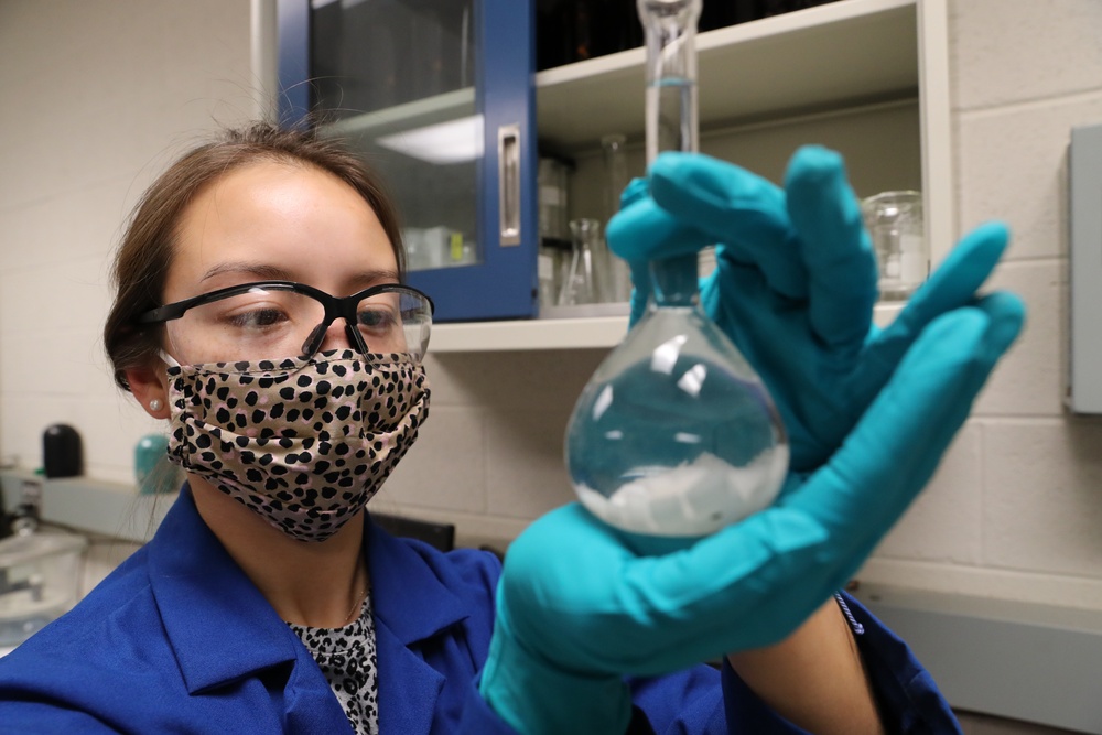 Scientist Meghan Griffiths observes the progress of samples she prepared for analysis via solvent dissolution