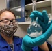 Scientist Meghan Griffiths observes the progress of samples she prepared for analysis via solvent dissolution