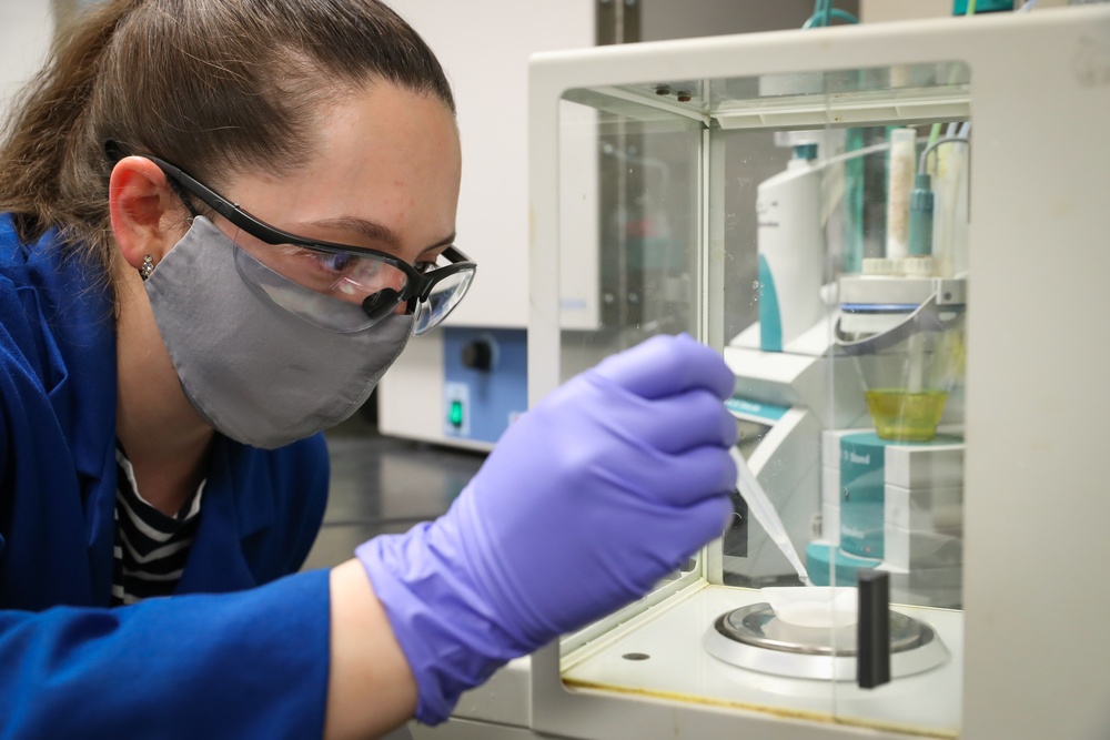 Scientist Nicolette Whitaker accurately weighs a sample
