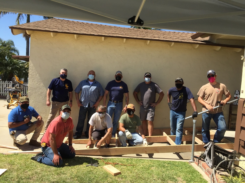 U.S. Navy Chief Petty Officers build wheelchair ramp for retired Senior Chief Cosgrove.