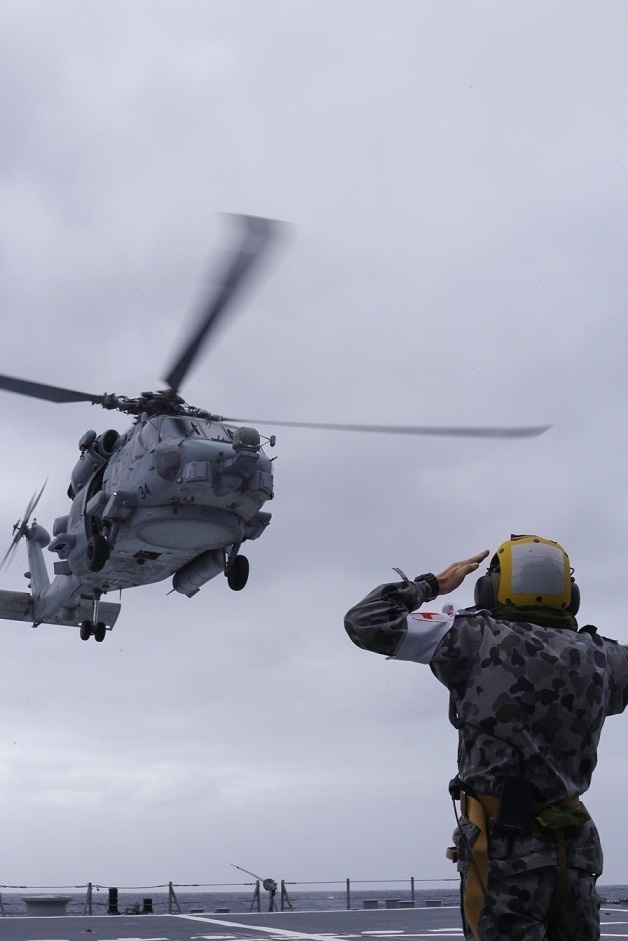 Australian sailors launch Sea Hawk helicopters aboard USS John Finn