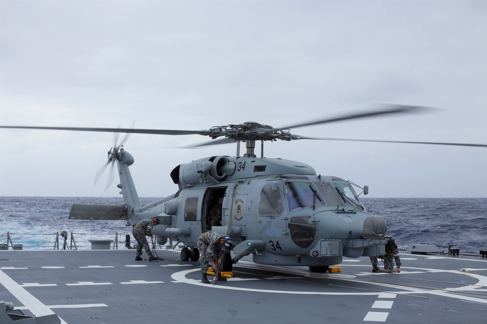 Australian sailors launch Sea Hawk helicopters aboard USS John Finn