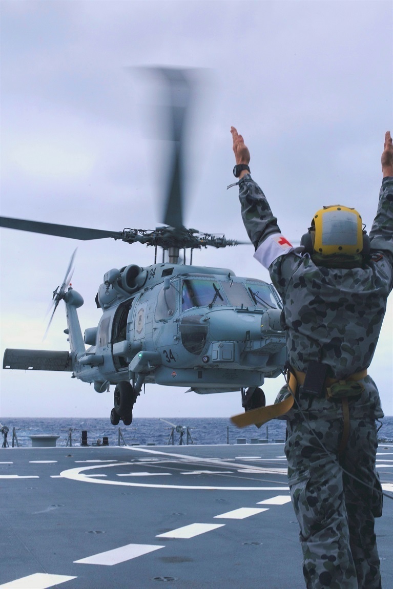 Australian sailors launch Sea Hawk helicopters aboard USS John Finn