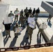 Sailors participate in a mock protest during an anti-terrorism training team drill