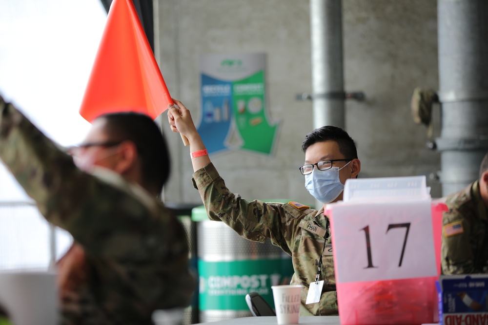 Soldier raises his flag during Community Vaccination Center operations