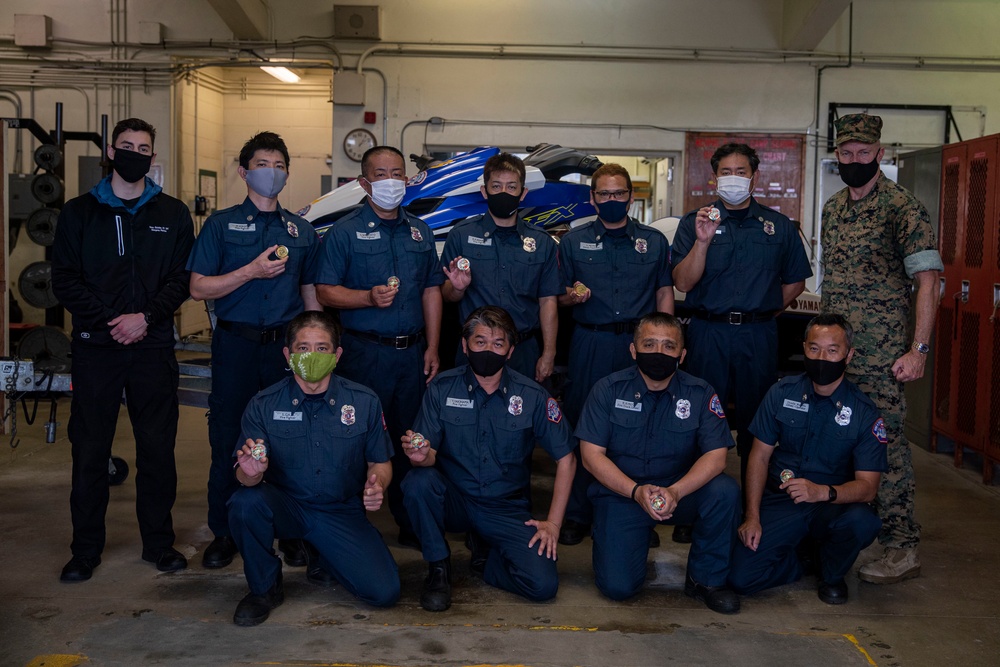 Camp Schwab fire fighters presented with challenge coins from MCIPAC