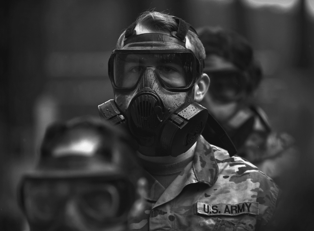 Military police don gas masks for annual training