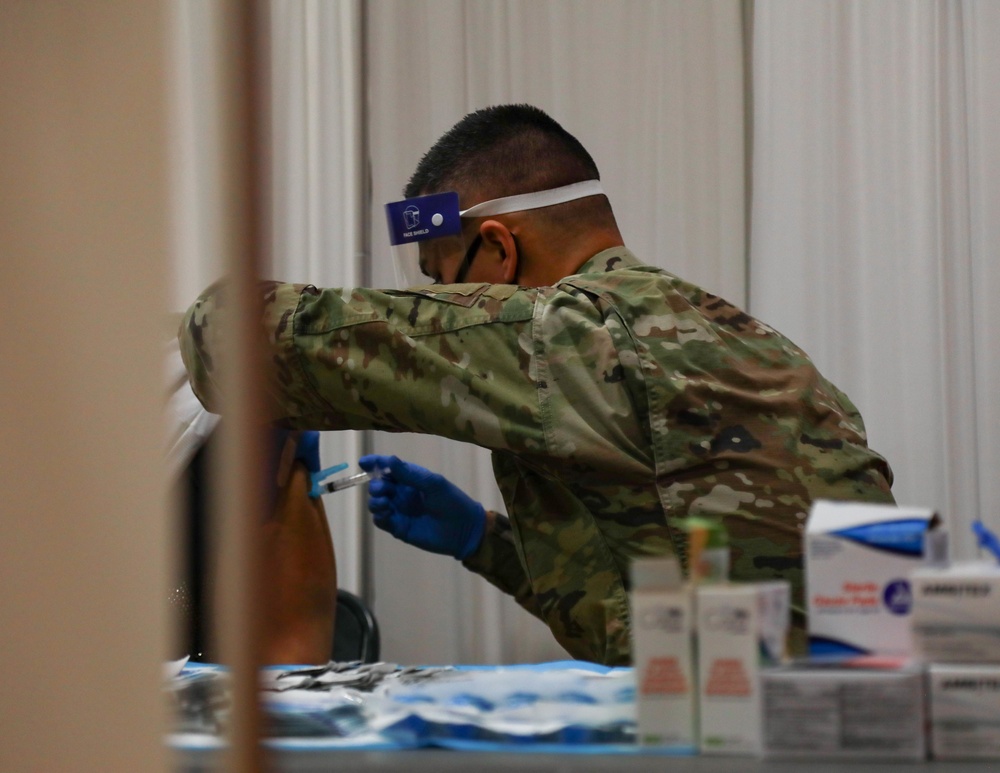 U.S. service members aid vaccination efforts at Elizabeth High School CVC