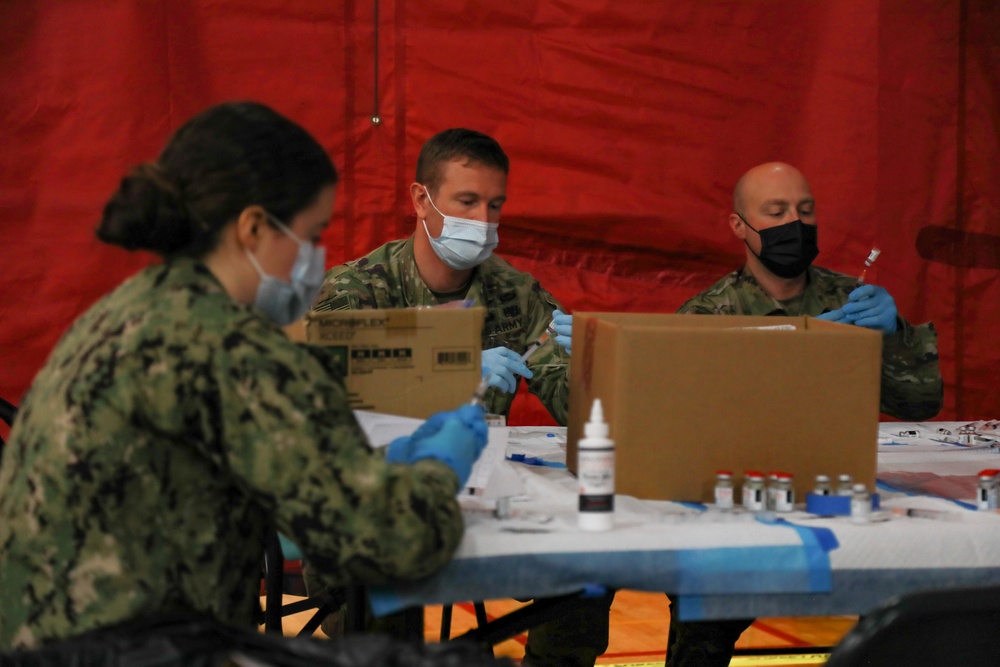 U.S. service members aid vaccination efforts at Elizabeth High School CVC