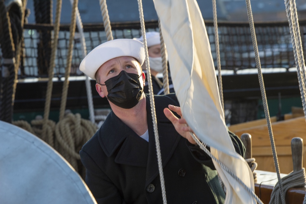 Boatswain’s Mate 2nd Class Kevin Crowder raises the church pennant for USS Constitution’s Easter Sunrise Service