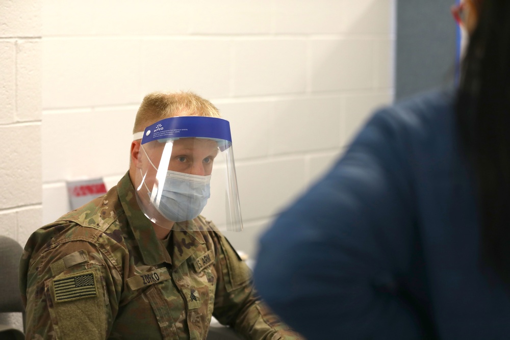 U.S. Army Soldiers aid in administering COVID-19 vaccines at Trenton Central High School CVC