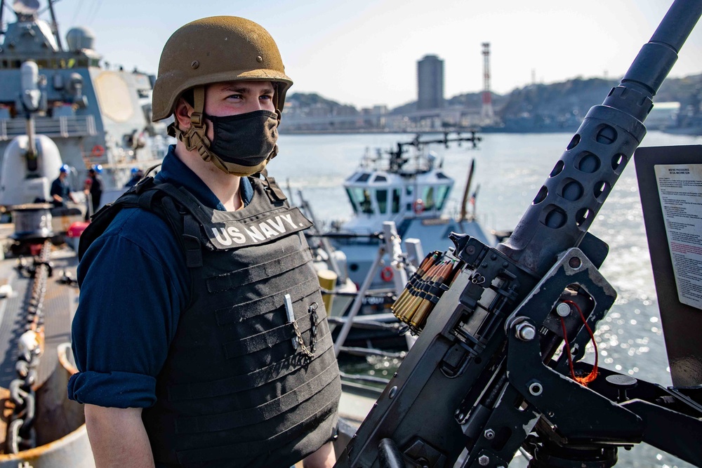 ET3 Alexander James mans a .50-caliber machine gun during sea and anchor detail