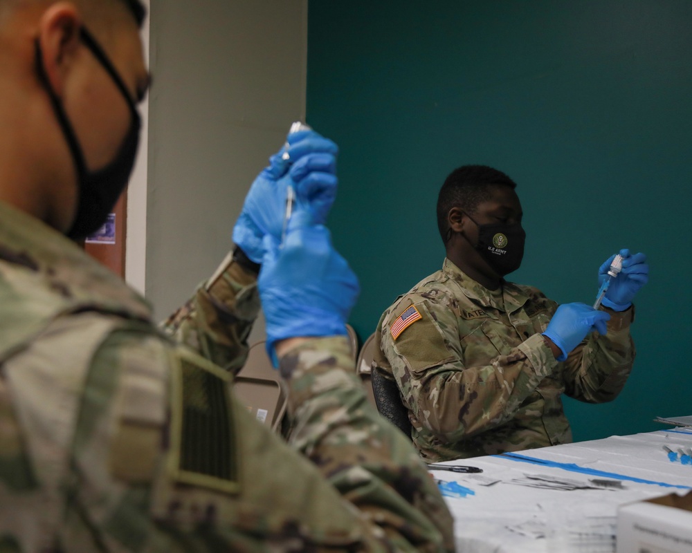 Service Members aid vaccination efforts at the Maureen Collier Memorial Senior Citizens Center CVC