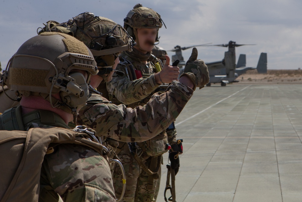 Green Berets jump out of Marine Corps helicopter