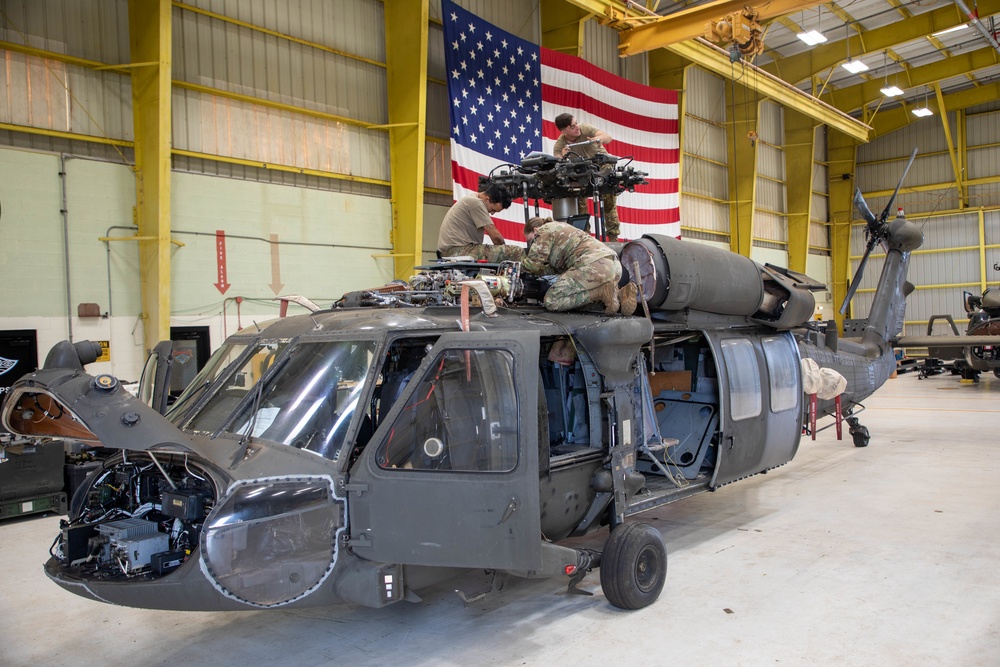 Soldiers pulling maintenance on a UH-60 Blackhawks on Wheeler Army Airfield, Hawaii. 