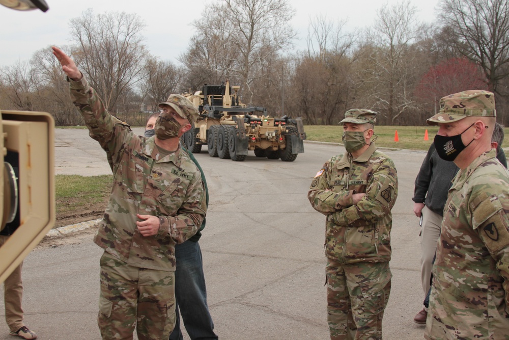 Maj. Hormann explains vehicle equipment to Werner and Dean