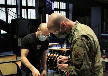 Glass museum hand crafts glass challenge coins for NY National Guard