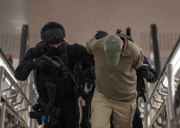 Qatari Special Forces escort a restrained gunman role-player during IS 21